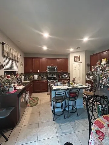 a kitchen with a table and chairs