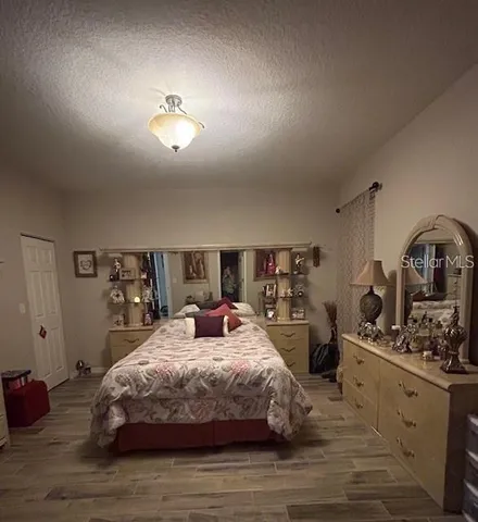 a bedroom with a bed window and dresser
