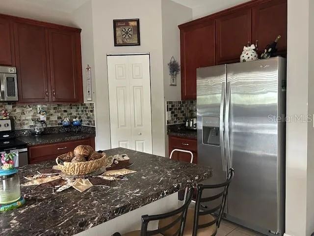 a kitchen with a table and chairs in it