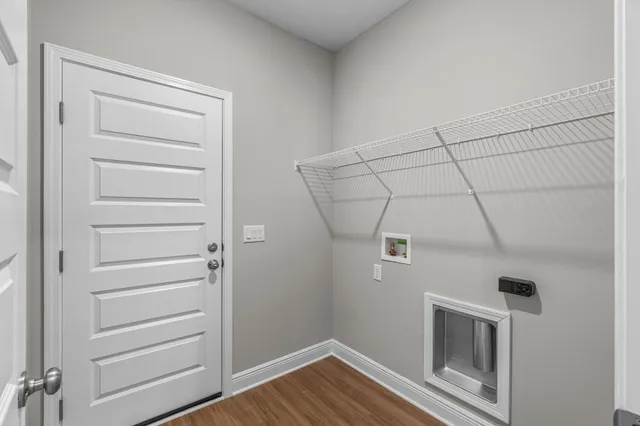 a view of a livingroom with an empty space and wooden floor