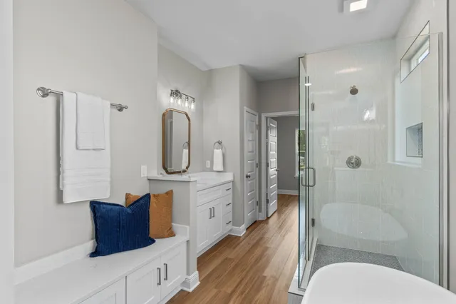 a bathroom with a toilet a sink and glass door