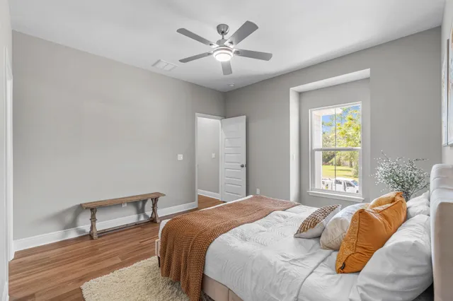 a bedroom with a bed and a chandelier