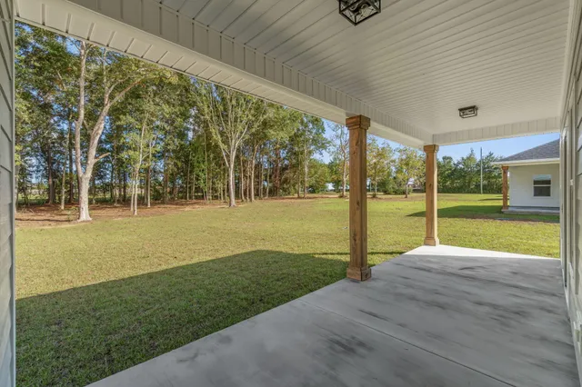 a view of a house with backyard and porch
