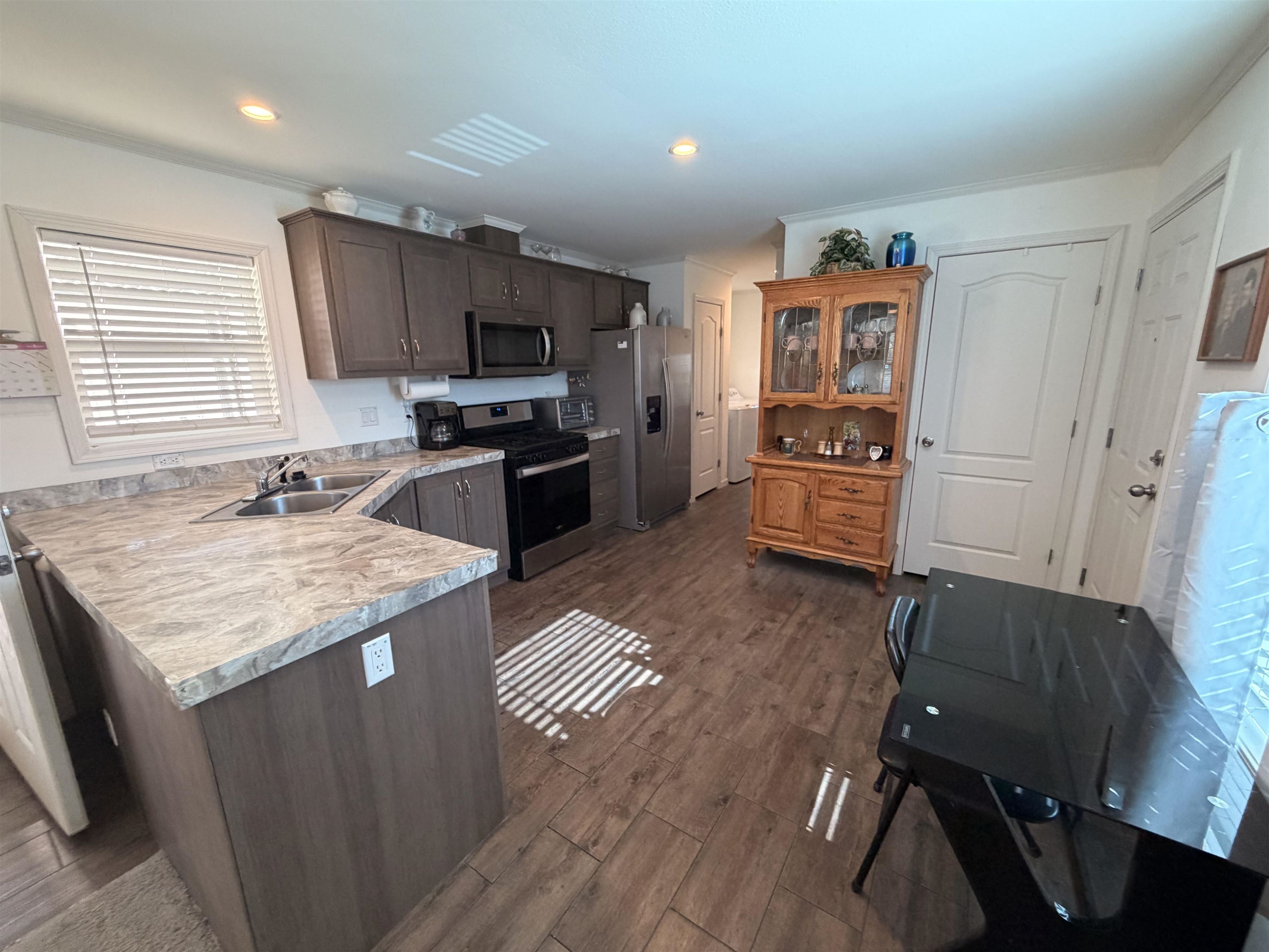 435 32 Road, Unit 826 Clifton, CO 81520 - Photo 5 of 17 a kitchen with granite countertop a sink appliances and cabinets
