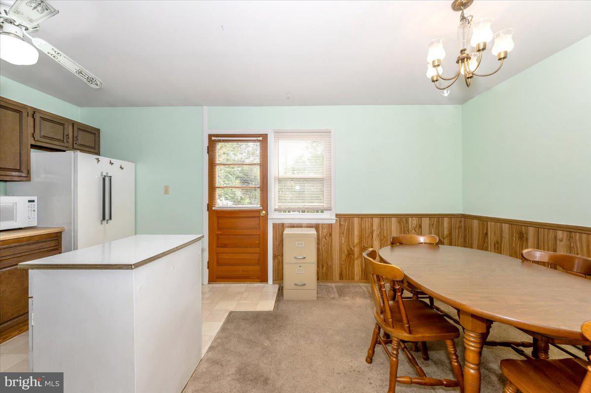 52 Wenner Drive Brunswick, MD 21716 - Photo 14 of 55 a dining room with stainless steel appliances a table and chairs