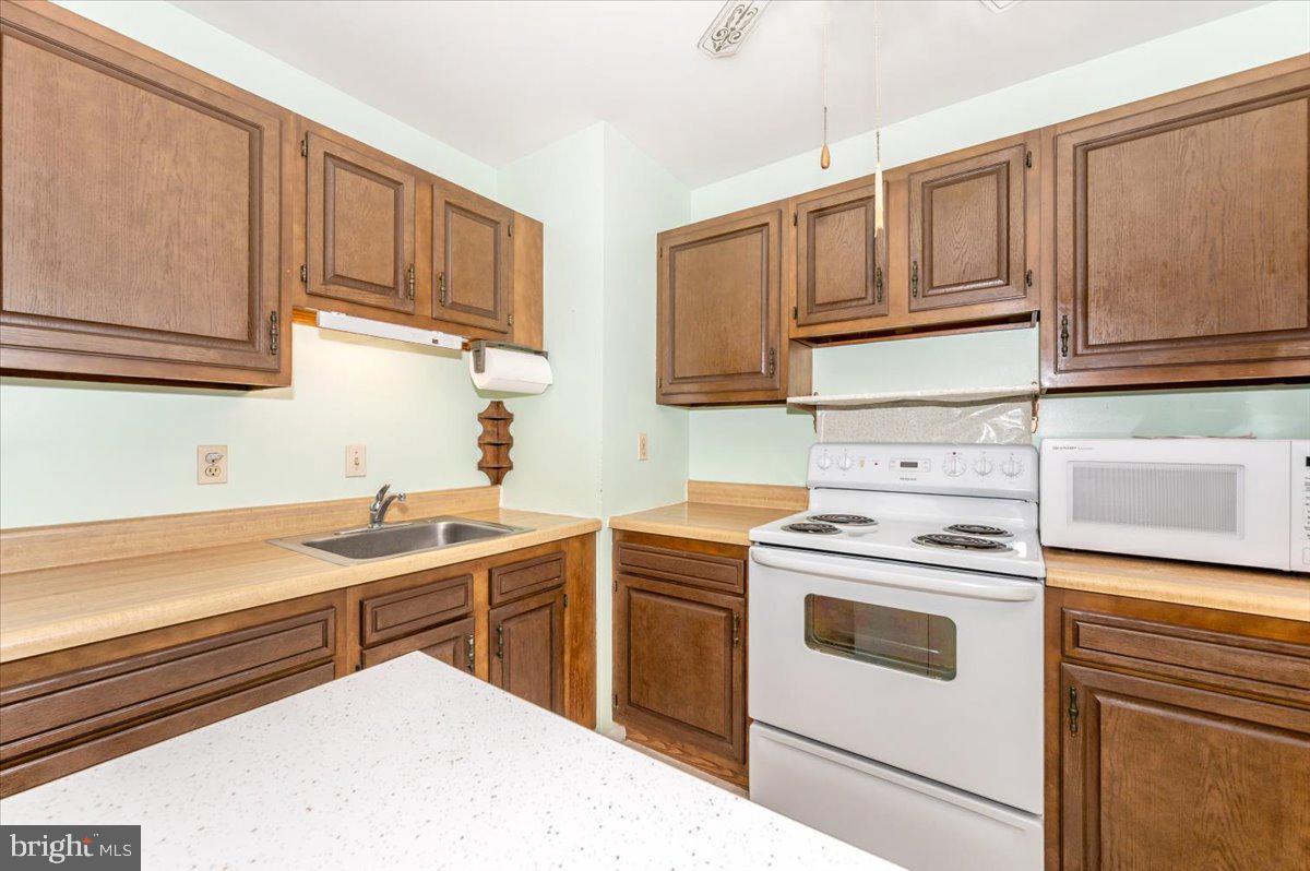 52 Wenner Drive Brunswick, MD 21716 - Photo 22 of 55 a kitchen with white cabinets stainless steel appliances and sink