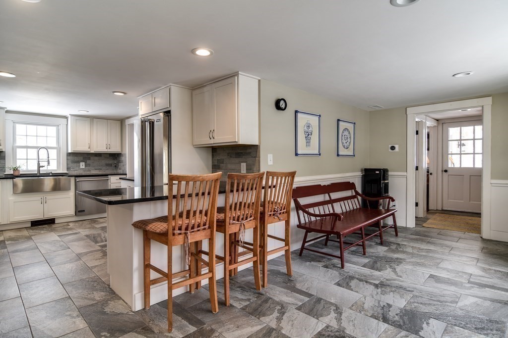 85 Walpole Street Dover, MA 02030 - Photo 12 of 39 a kitchen with a dining table chairs and refrigerator