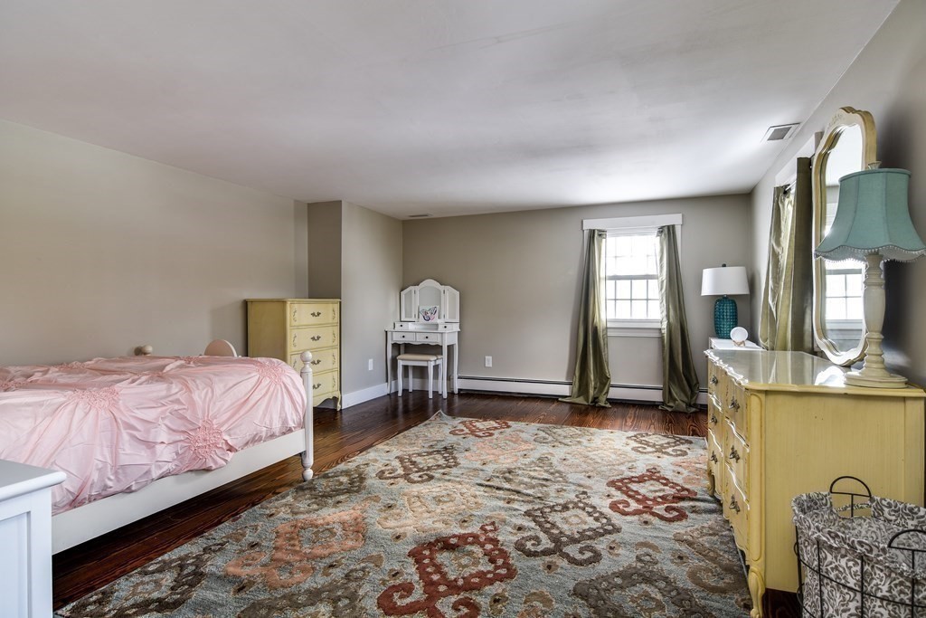 85 Walpole Street Dover, MA 02030 - Photo 27 of 39 a bedroom with a bed and a dresser in it