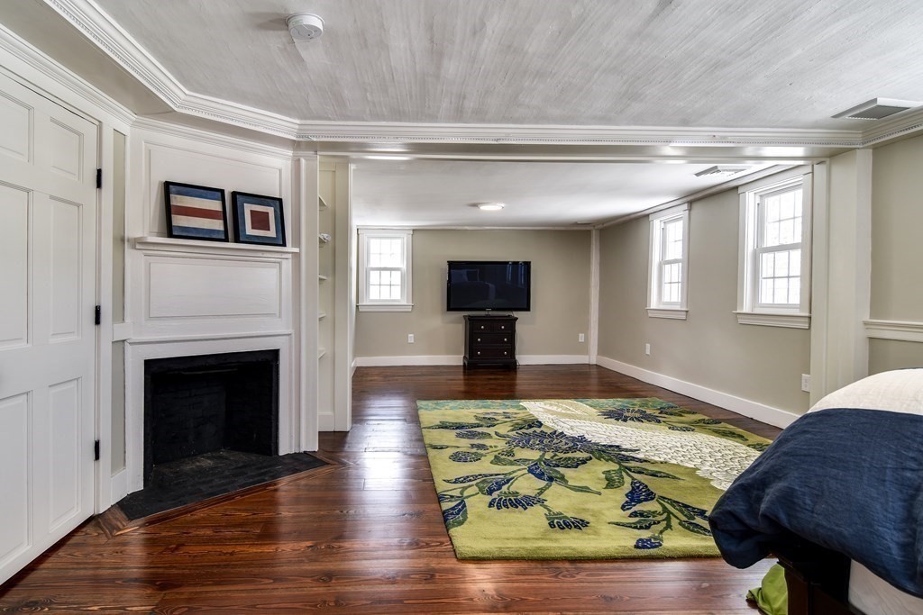 85 Walpole Street Dover, MA 02030 - Photo 29 of 39 a living room with kitchen and a fireplace