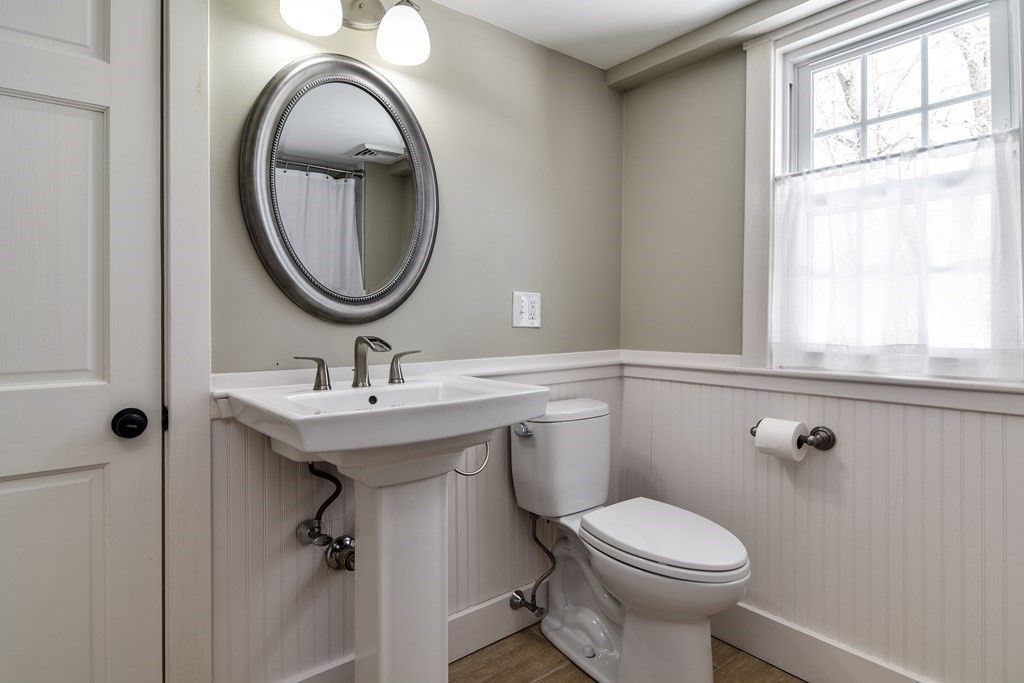 85 Walpole Street Dover, MA 02030 - Photo 30 of 39 a bathroom with a granite countertop toilet sink and mirror