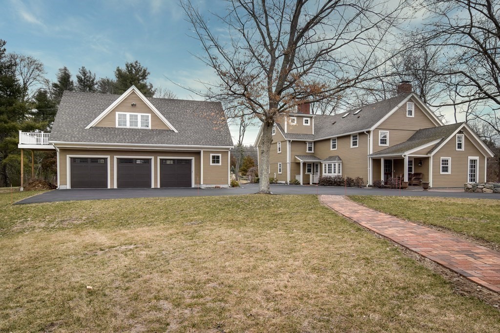 85 Walpole Street Dover, MA 02030 - Photo 3 of 39 a front view of a house with a garden