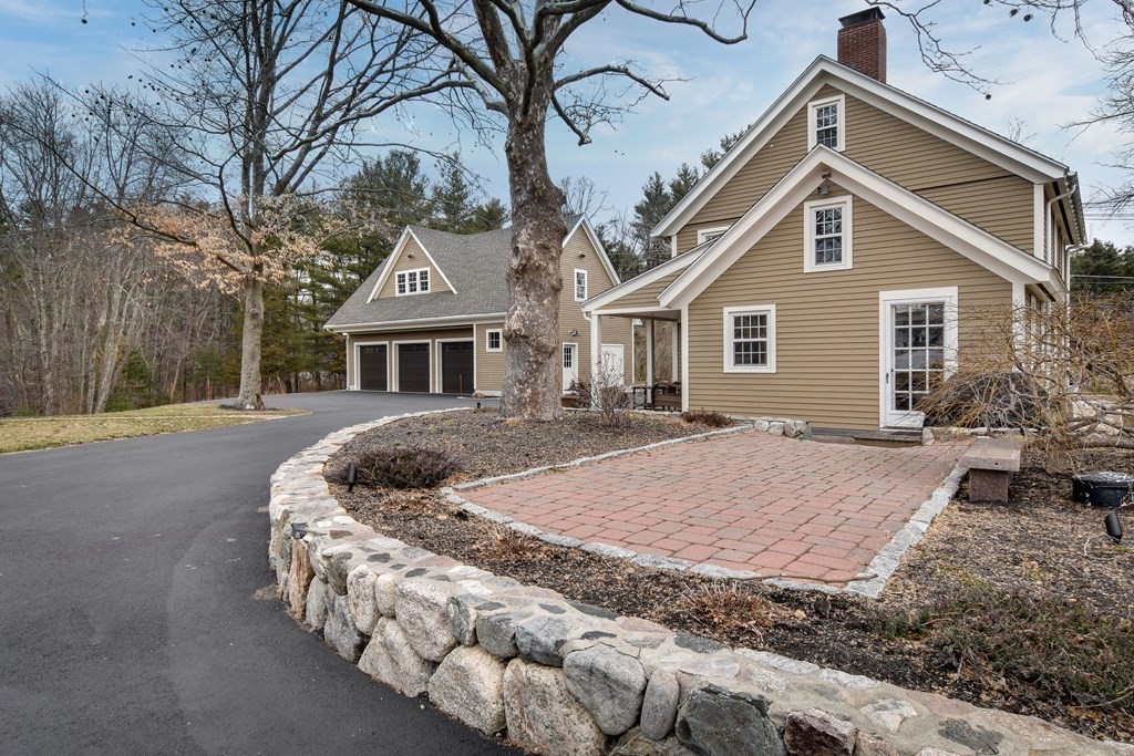85 Walpole Street Dover, MA 02030 - Photo 7 of 39 a front view of house with yard and trees around