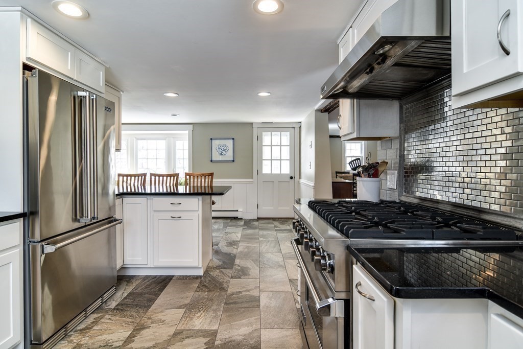 85 Walpole Street Dover, MA 02030 - Photo 9 of 39 a kitchen with granite countertop a stove and a refrigerator