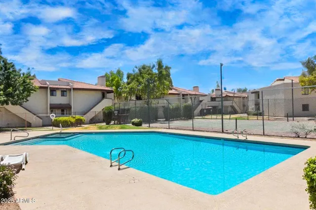 a view of a swimming pool with a lounge chairs