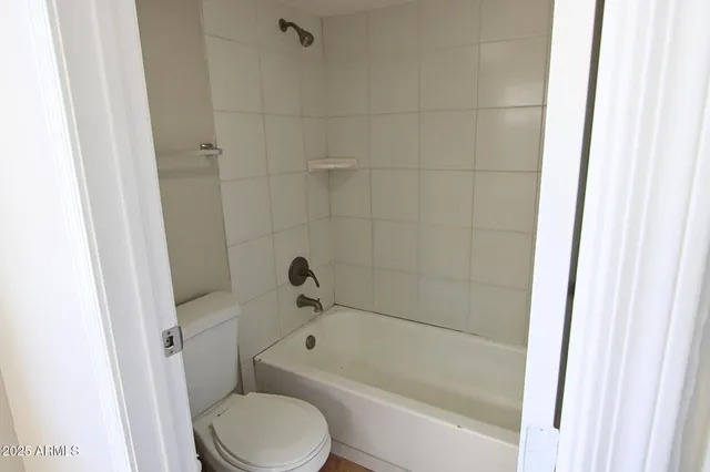 a toilet sitting next to a bath tub