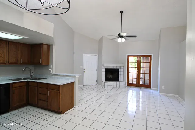 a kitchen with kitchen island granite countertop a sink a counter top space and cabinets