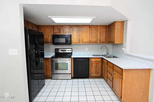 a kitchen with a sink a stove and cabinets