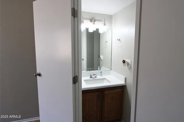 a bathroom with a double vanity sink and mirror