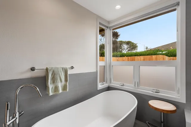 a bathroom with a granite countertop sink and a large mirror