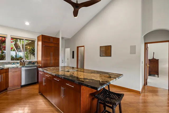 a kitchen with stainless steel appliances granite countertop a stove and a sink