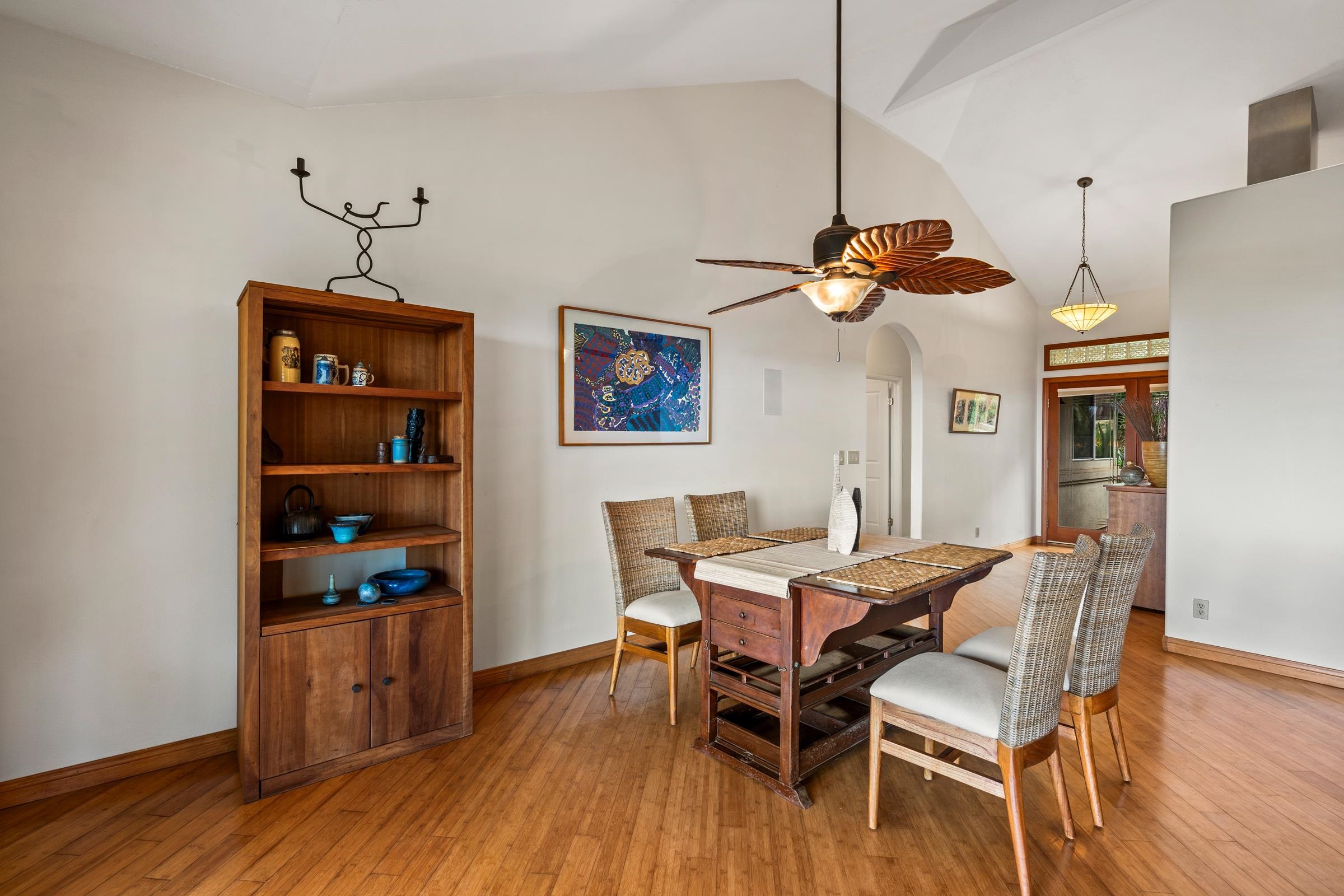 33 U'au Place Kula, HI 96790 - Photo 33 of 50 a dining room with wooden floor a chandelier a wooden table and chairs