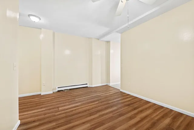 a view of room with wooden floor