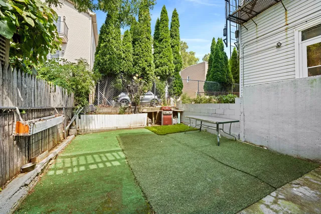 a view of backyard with sitting area