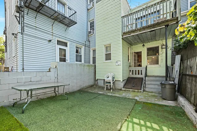 a backyard of a house with table and chairs