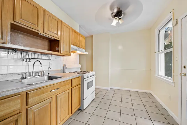 a kitchen with a sink a stove and cabinets