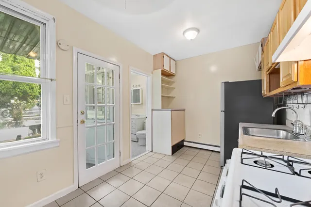 a kitchen with a refrigerator and a stove