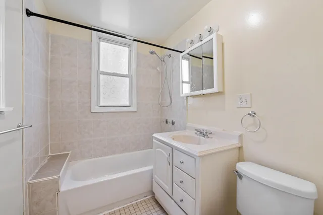 a bathroom with a sink toilet vanity and bathtub