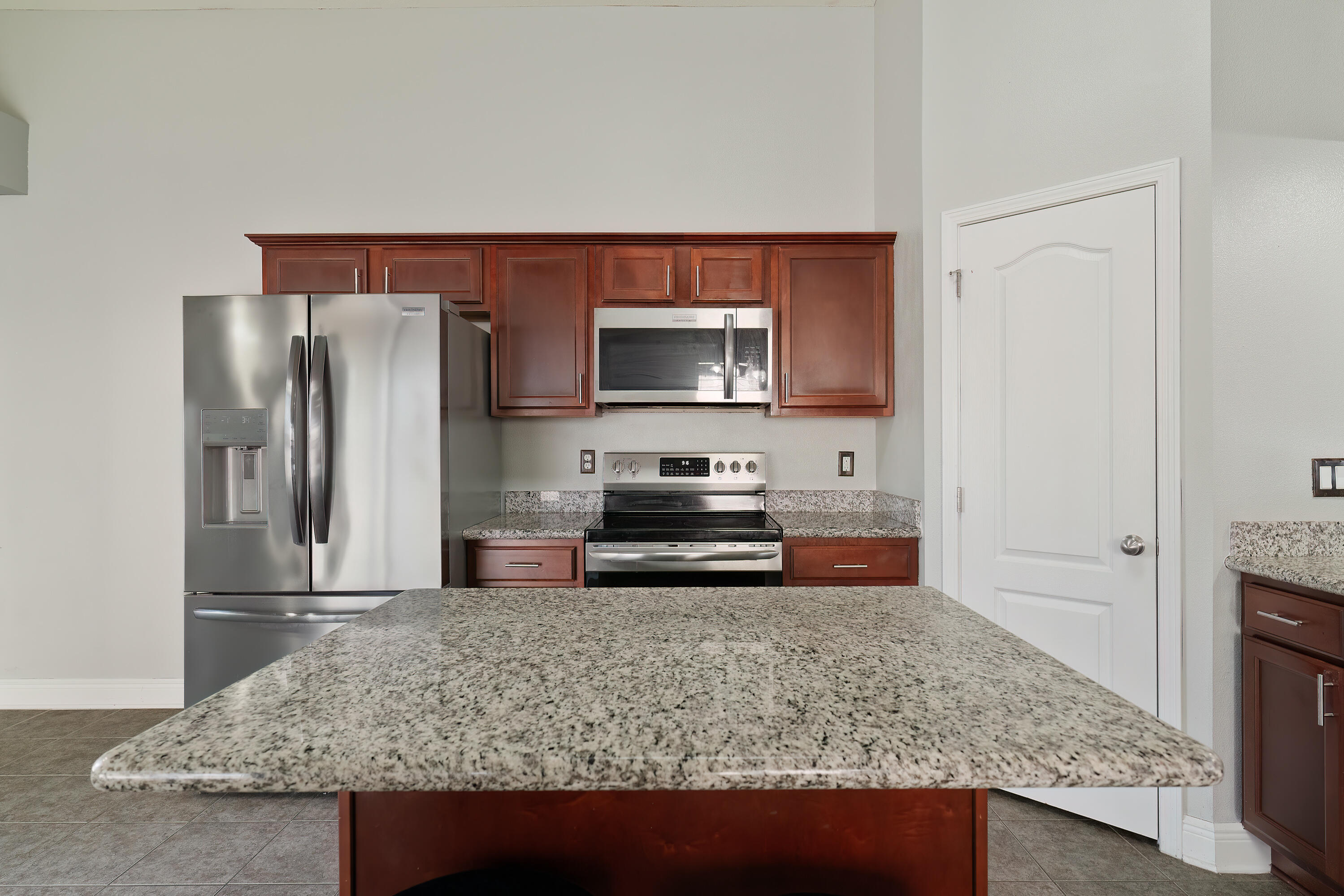 4633 Hermosa Road Crestview, FL 32539 - Photo 19 of 53 a kitchen with stainless steel appliances granite countertop a sink stove and refrigerator