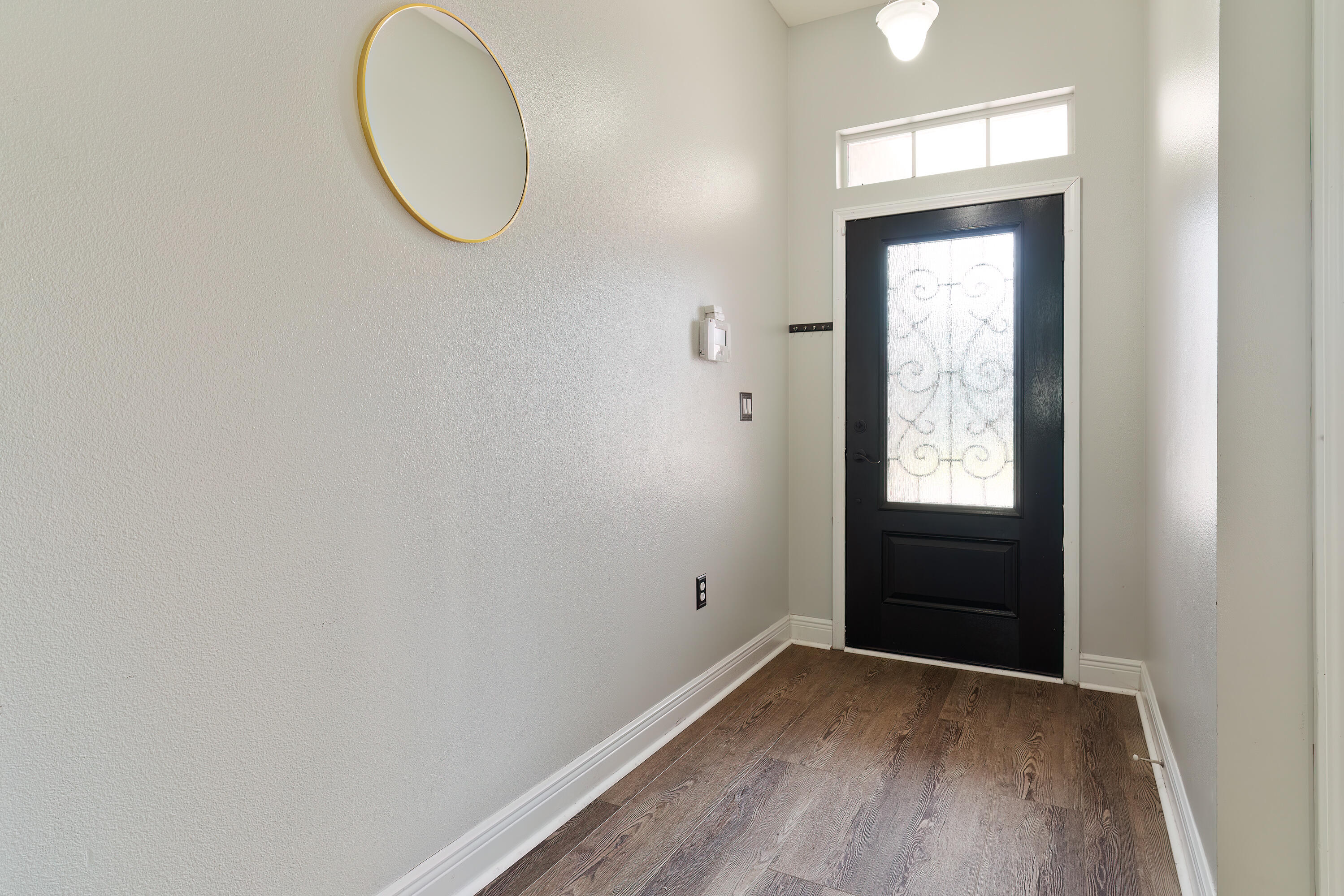 4633 Hermosa Road Crestview, FL 32539 - Photo 4 of 53 an empty room with wooden floor and windows