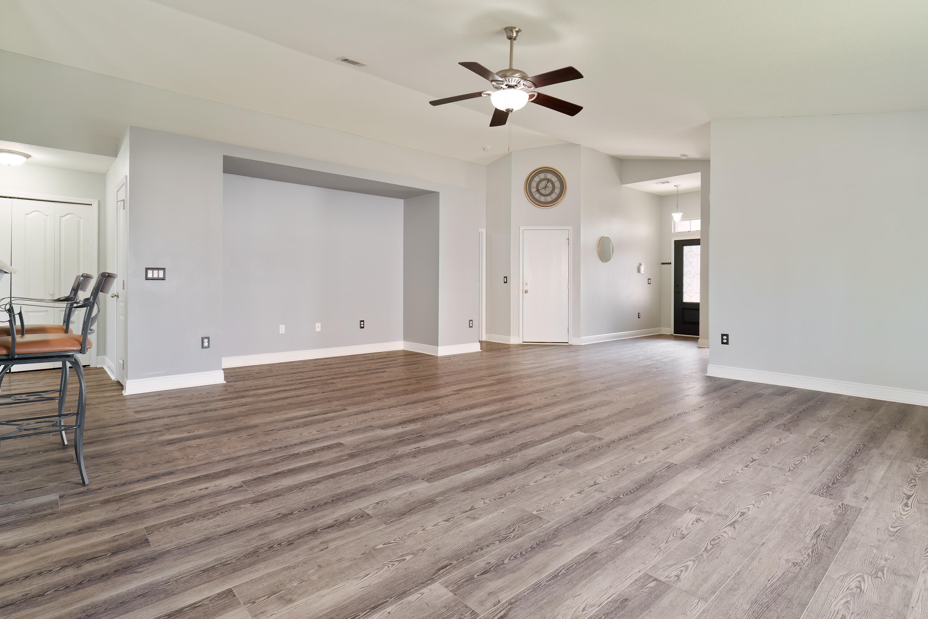 4633 Hermosa Road Crestview, FL 32539 - Photo 8 of 53 an empty room with wooden floor and ceiling fan