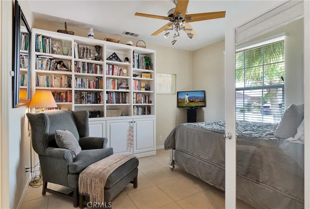 a living room with furniture and a book shelf