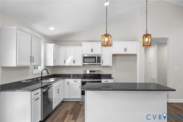 a kitchen with a sink a stove and cabinets