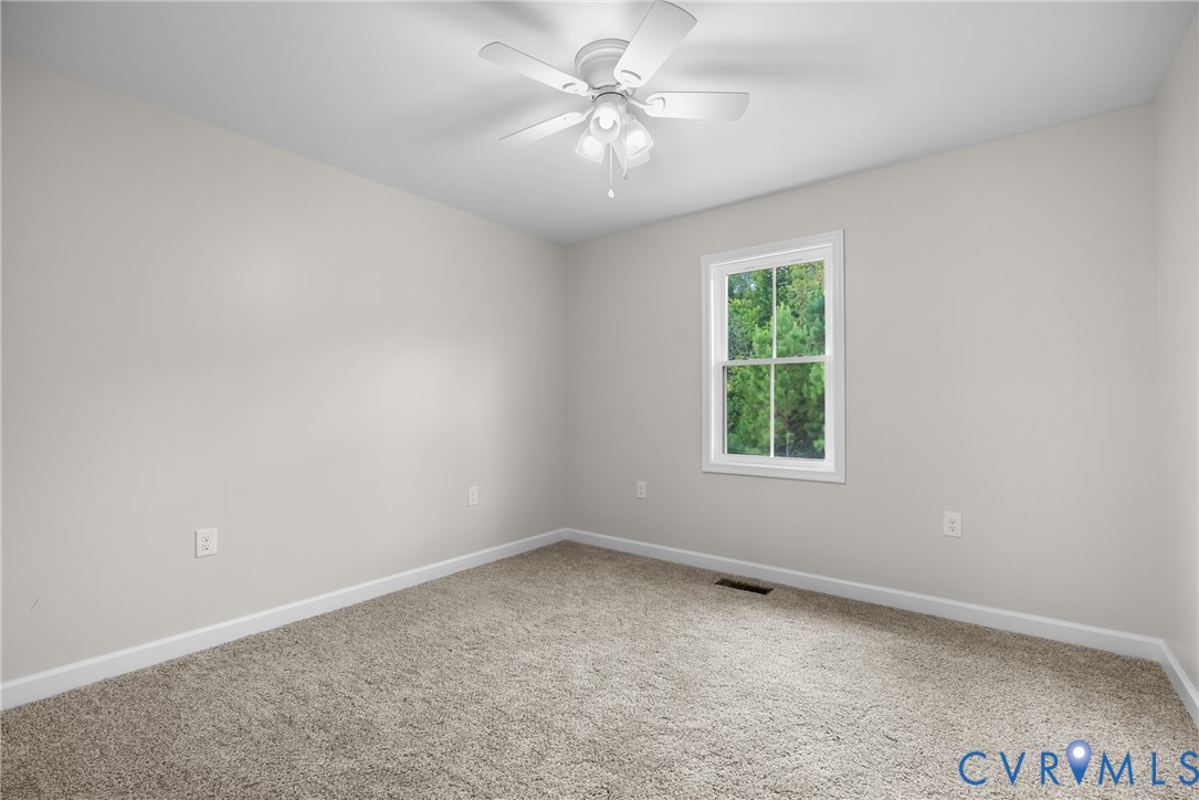 1373 Twenty Two Road Pamplin, VA 23958 - Photo 27 of 39 an empty room with windows and ceiling fan