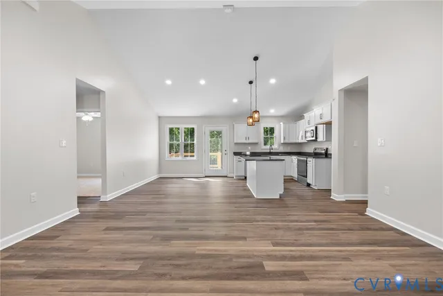 a view of kitchen with kitchen island and stainless steel appliances