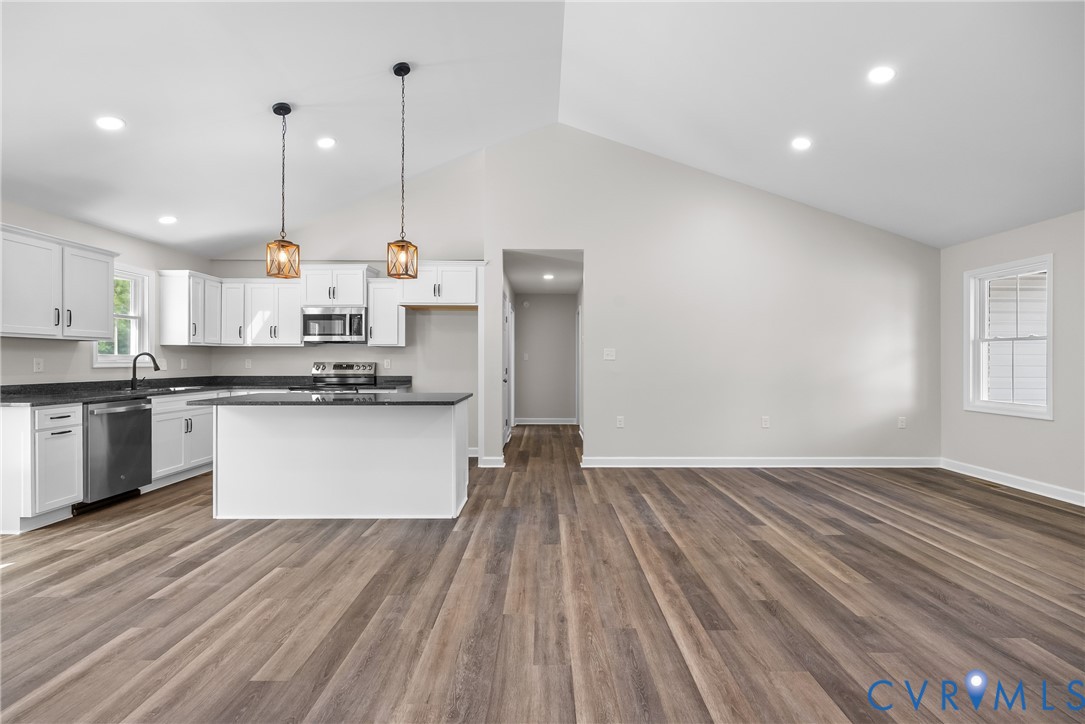 1373 Twenty Two Road Pamplin, VA 23958 - Photo 10 of 39 a kitchen with stainless steel appliances granite countertop a sink a stove and white cabinets with wooden floor