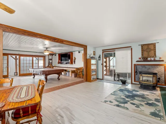 a living room with furniture a rug and a large window
