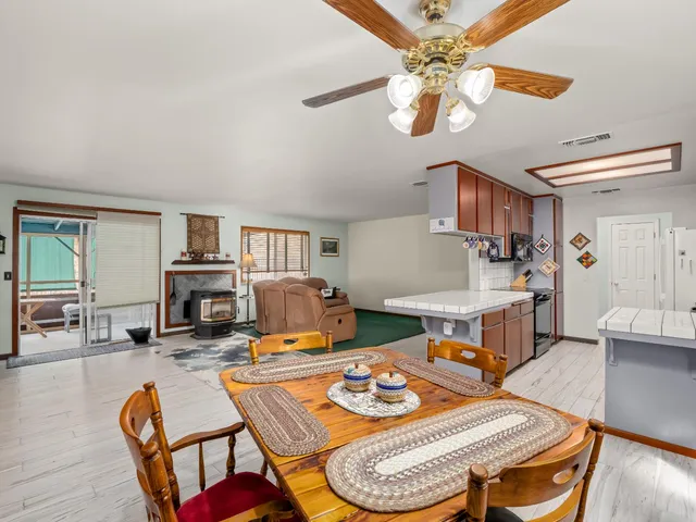 a kitchen that has a lot of cabinets and wooden floor
