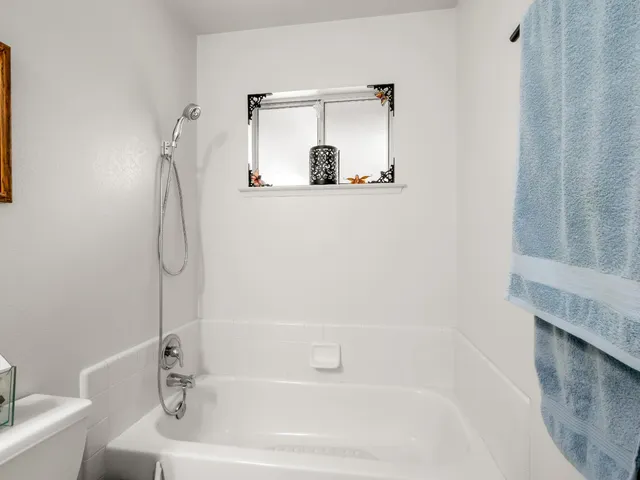 a bedroom with furniture and large windows