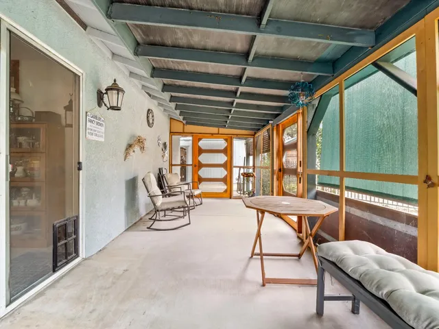 a view of a house with a big yard and potted plants