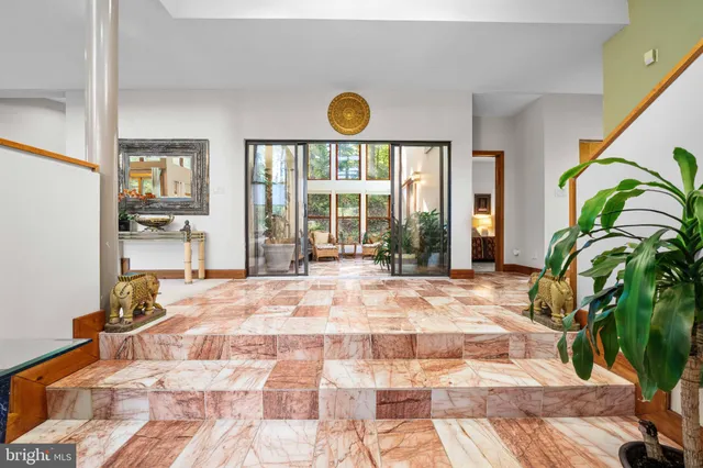 a living room with fireplace furniture and a large window