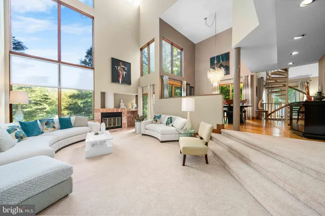 a large kitchen with kitchen island a stove a sink a refrigerator and a granite counter tops with white cabinets