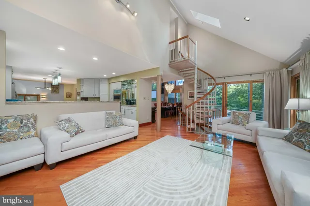 a living room with furniture and floor to ceiling windows