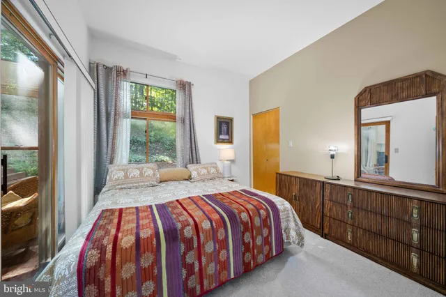 a bedroom with a large bed and a large window