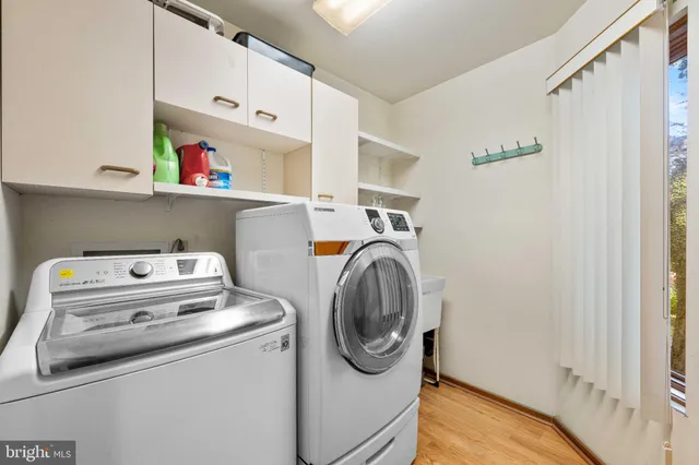 a large spacious bathroom with a double vanity sink a toilet a mirror and shower