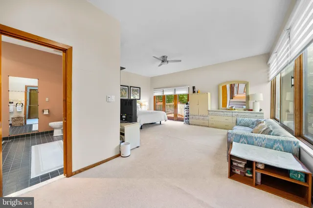 a view of living room with furniture and a mirror