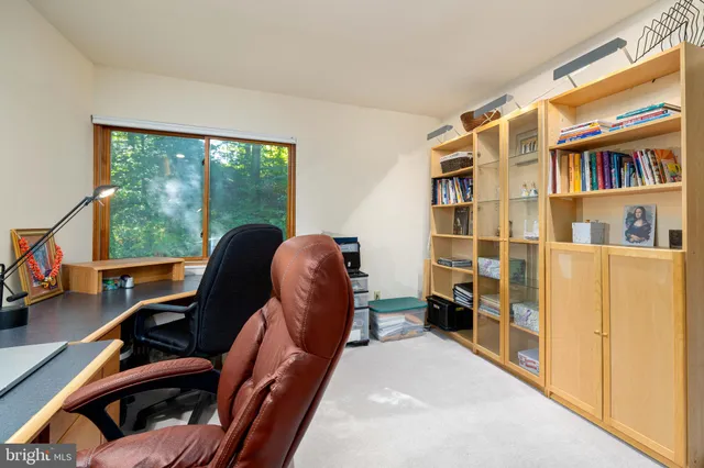 a picture of a room with a white wall and a painting